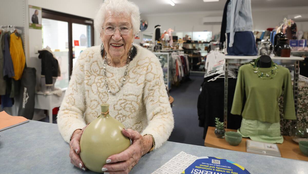 Annie Kersten, who turns 100 on Saturday, spends half a day each fortnight at the Corrimal Vinnies store and takes pride in her job pricing and positioning the bric-a-brac that comes in. Picture by Adam McLean. 