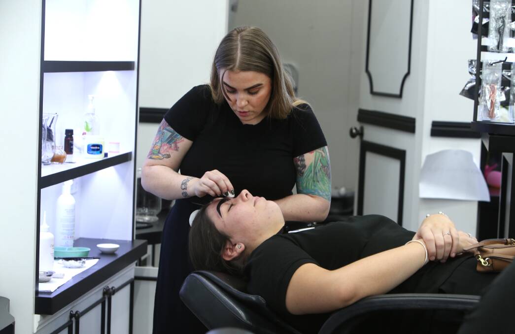 At Doll Face eyebrow bar - a personal service business affected by Tuesday's announcement - manager Gemma Armstrong was "pretty gutted", but trying to stay positive as the last customers came in before closure. Picture: Sylvia Liber.