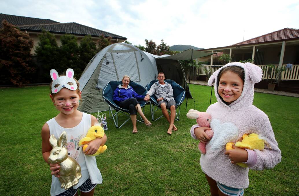 Mount Ousley residents Tija and Jay Hurry and their daughters Amber, 8, and Imogen, 6 have set up camp in their yard for the Easter long-weekend. Picture: Sylvia Liber.