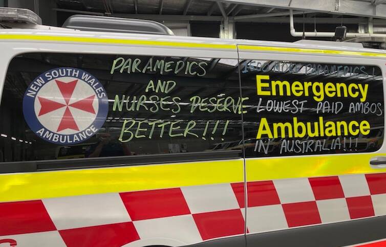 Paramedics have written chalk slogans on some ambulances during their industrial action. Picture: Supplied.