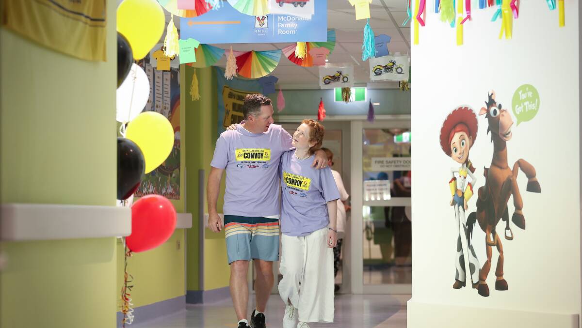 Albion Park's Adam Henley and 13-year-old daughter Kayla walking through the corridor of the revamped children's ward. Picture by Adam McLean
