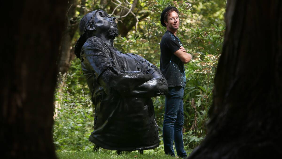 Prize winner: Artist Louis Pratt with his sculpture King Coal: “an arrogant character unwilling to change and unaware of his impending doom”. Picture: Adam McLean.