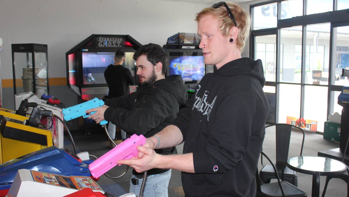 FUN: Jeremy Burke and Will Billington playing one of the shooting games.