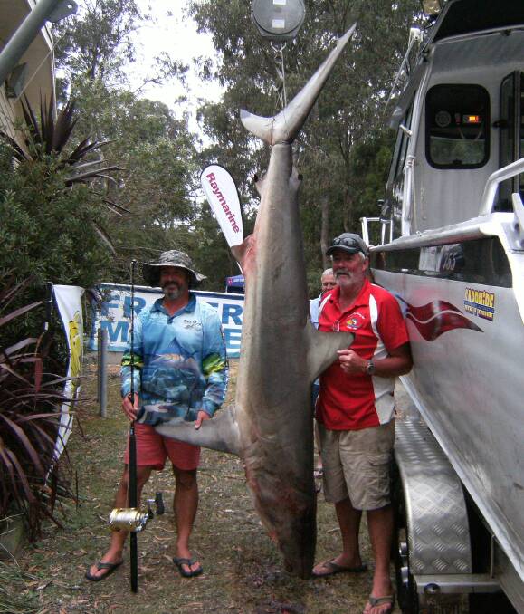 Catch of the day: Trever Chippendale (left) and Geoff McMahon with their 137kg game shark captured on Monday night March 7 as part of week-long fishing competition. Picture: Eden Amateur Fishing Club.