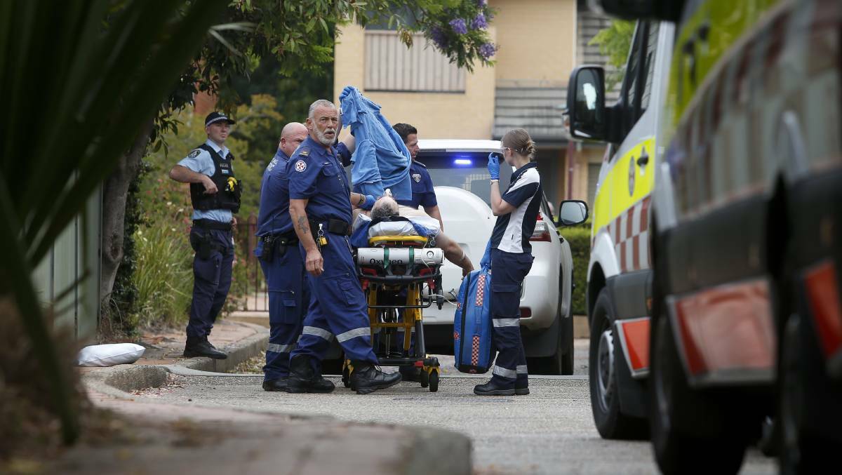 Police and paramedics treat David Delaney after he stabbed himself in the chest in November last year. Picture: Anna Warr.