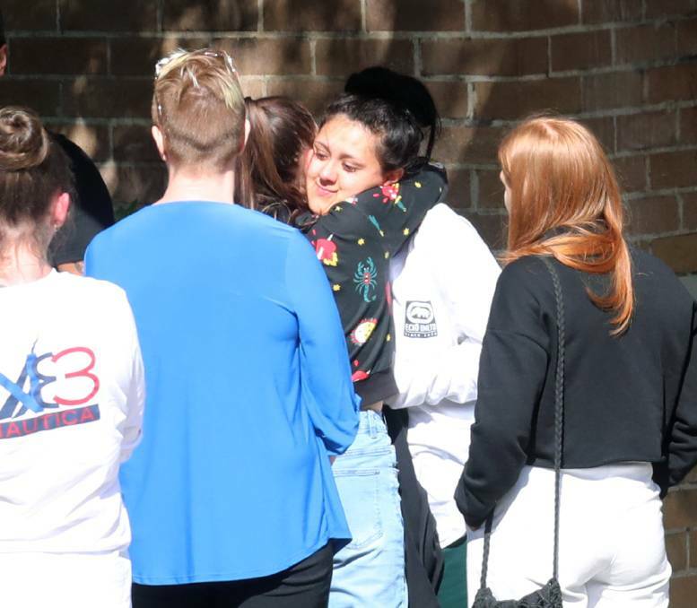 Nikita Campbell (facing camera) hugs friends and family after being granted bail in August last year.