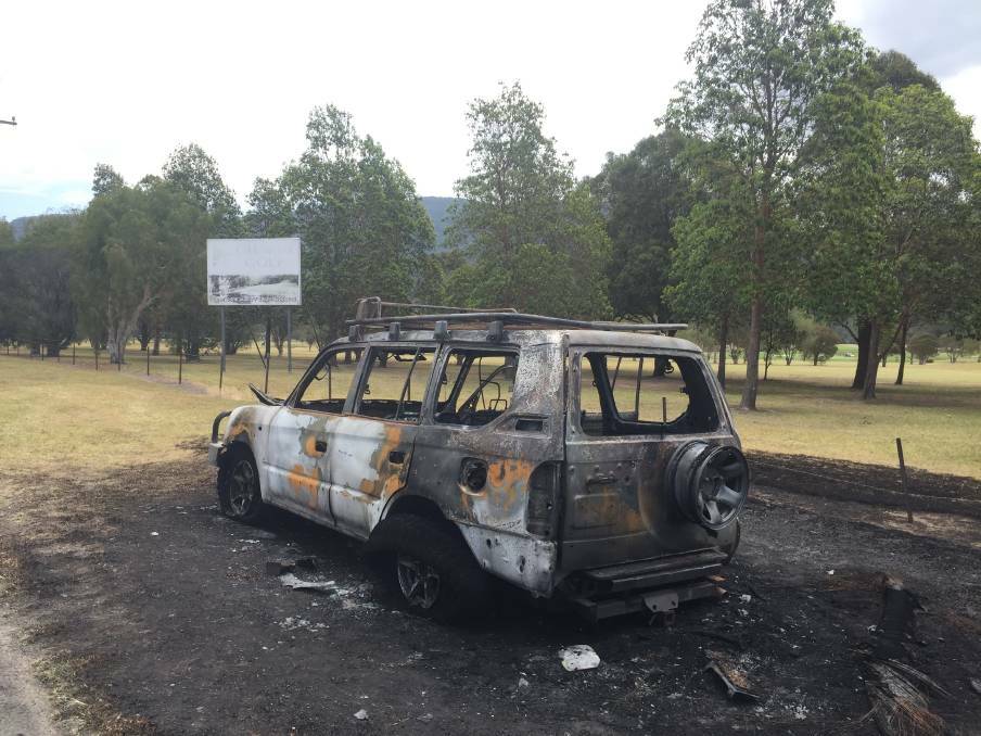 On fire: This Toyota Prado was found alight in Calderwood Road, Calderwood, less than 90 minutes after the shootings took place. Picture: Sylvia Liber