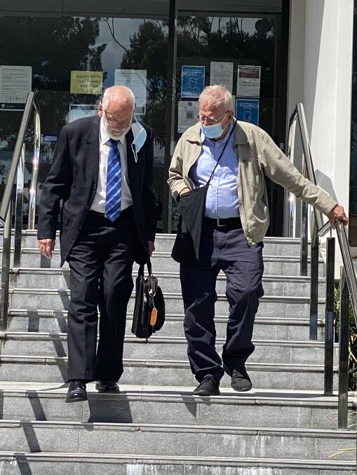 Remorseful: Neville Little (right) leaves Wollongong Courthouse yesterday in the company of his lawyer. The 85-year-old says he is sorry for causing a crash that injured a cyclist at Helensburgh.