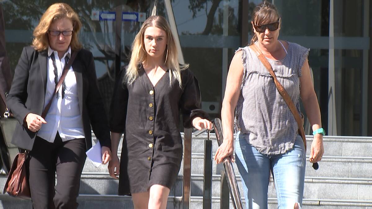 Casey Holmes (middle) flanked by her lawyer, Cate Doosey (left) and her mother (right) leaves Wollongong courthouse on Tuesday. 