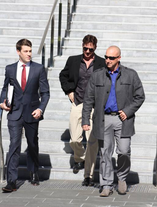 Busted: Former Lake Illawarra cop Jason Hall (right), leaves Wollongong courthouse on Monday with lawyer Matthew Ward (left) and a supporter. 