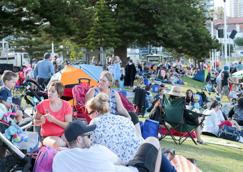 Building up: Crowds gathered at Belmore Basin from 5pm, covering the grassed area in camping chairs and picnic blankets. Picture: Adam McLean