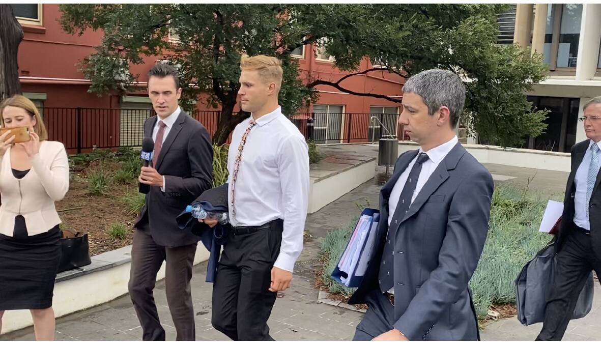 Dragons star Jack de Belin (white shirt) leaves Wollongong courthouse on Thursday. The case against he and co-accused, Callan Sinclair, will return to court in April.
