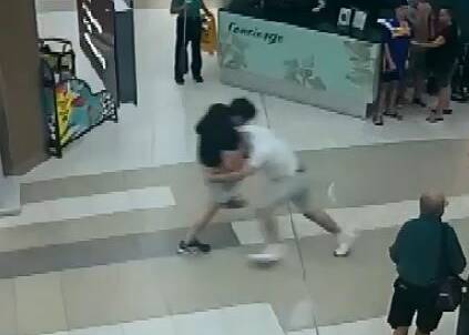 Fight scene: A CCTV still of two of the men mid-brawl. Police said several shoppers witnessed the violence.