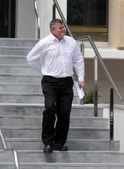 In pain: Roger Reeves' pain is visible as he struggles to make it down the stairs outside Wollongong courthouse last month.
