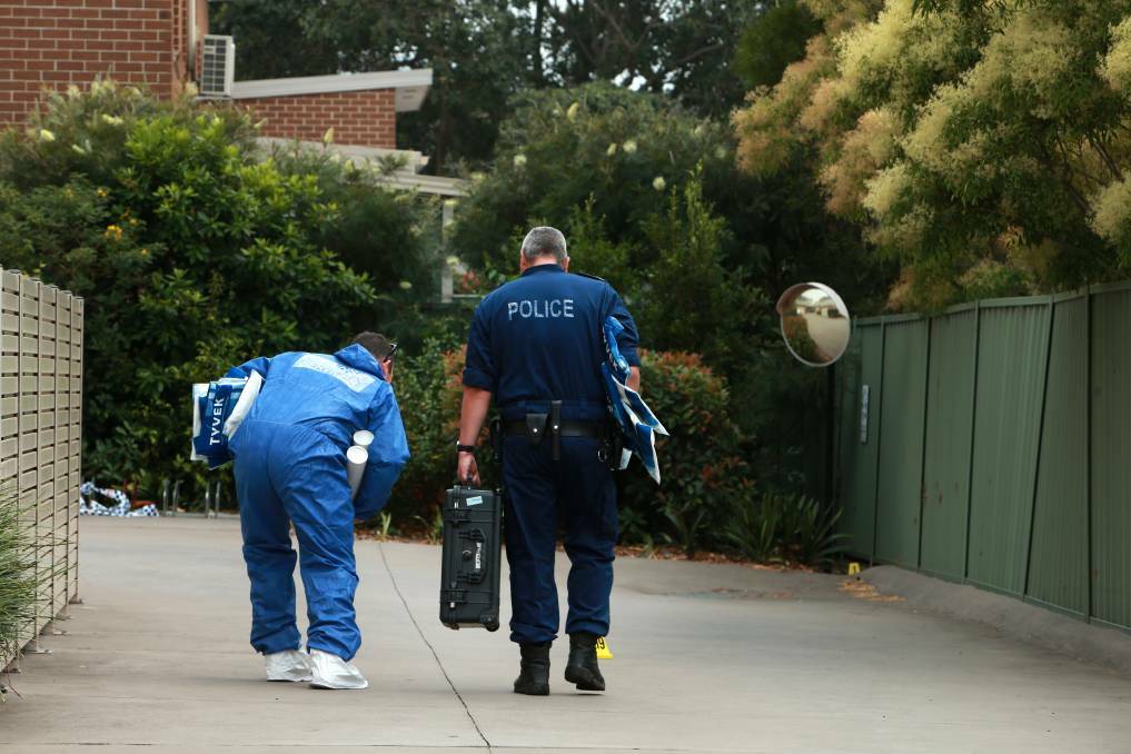 Gathering evidence: Crime scene investigators at the Campbell Street unit in 2019. Picture: Sylvia Liber
