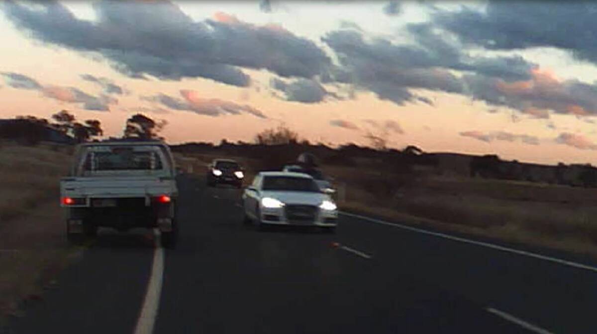A screenshot of dashcam footage taken by Grace Stevens where a ute had to pull off onto the side of the road in order to avoid a collision with a white car driving in the opposite direction. 