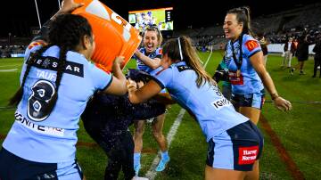 HAPPY DAYS: Sam Bremner (centre) helps deliver the traditional post-match Gatorade shower to Sky Blues coach Kylie Hilder on Friday night. Picture: AAP