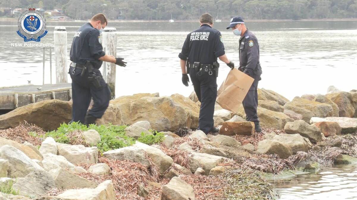 SEARCH: Homicide Squad detectives and South Coast Police District officers search waters around the Sanctuary Point Boat Ramp on Wednesday. Image: NSW Police