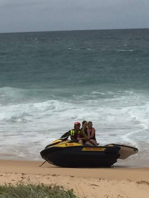 SAFE: Nowra-Culburra Surf Lifesaving member Josh Pakes safley back on firm ground with the two rescued paddleboarders. Image: Josh Pakes