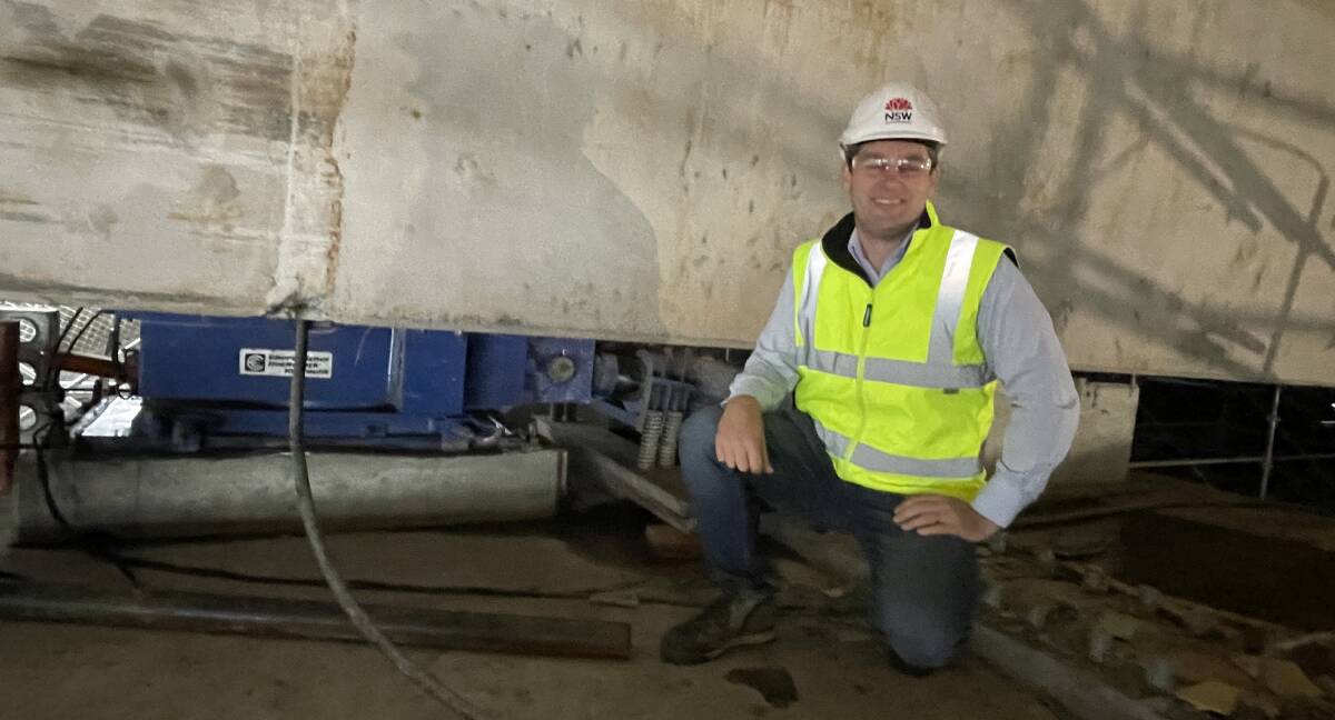 POWERFUL HEART: Transport for NSW Nowra bridge project manager, Ryan Whiddon, with one of the hydraulic jacks used to launch the 20 metre deck into place.