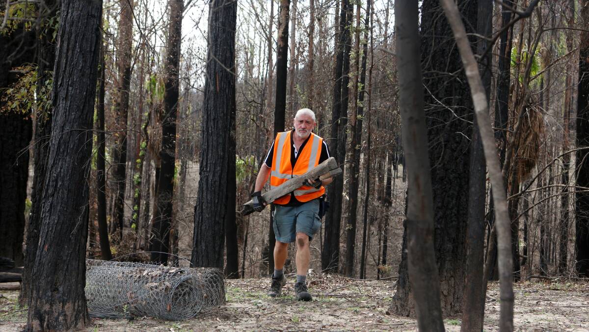HARD WORK: BlazeAid volunteer Greg Murphy clears a Kangaroo Valley property. Photo: Sylvia Liber