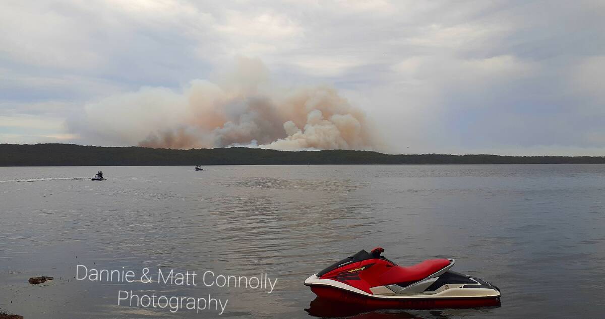 CLEAR VIEW: The Booderee National Park fire from Sanctuary Point boatramp. Photo: Dannie and Matt Connolly Photography
