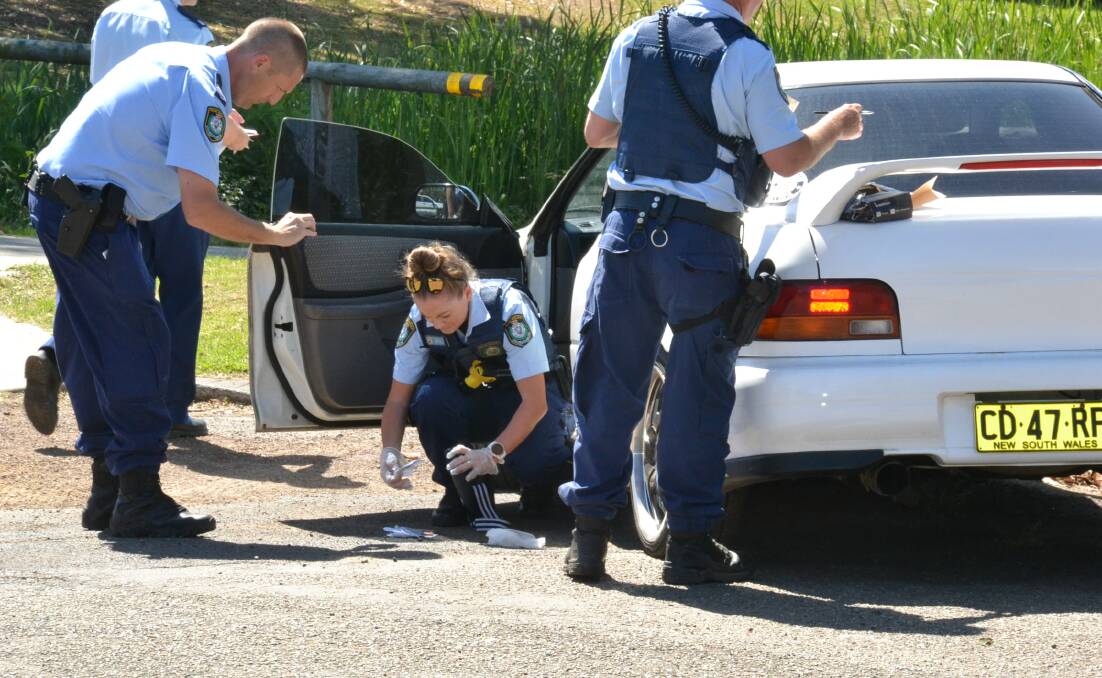Nowra police comb through the vehicle for evidence following Tuesday afternoon's dramatic pursuit.