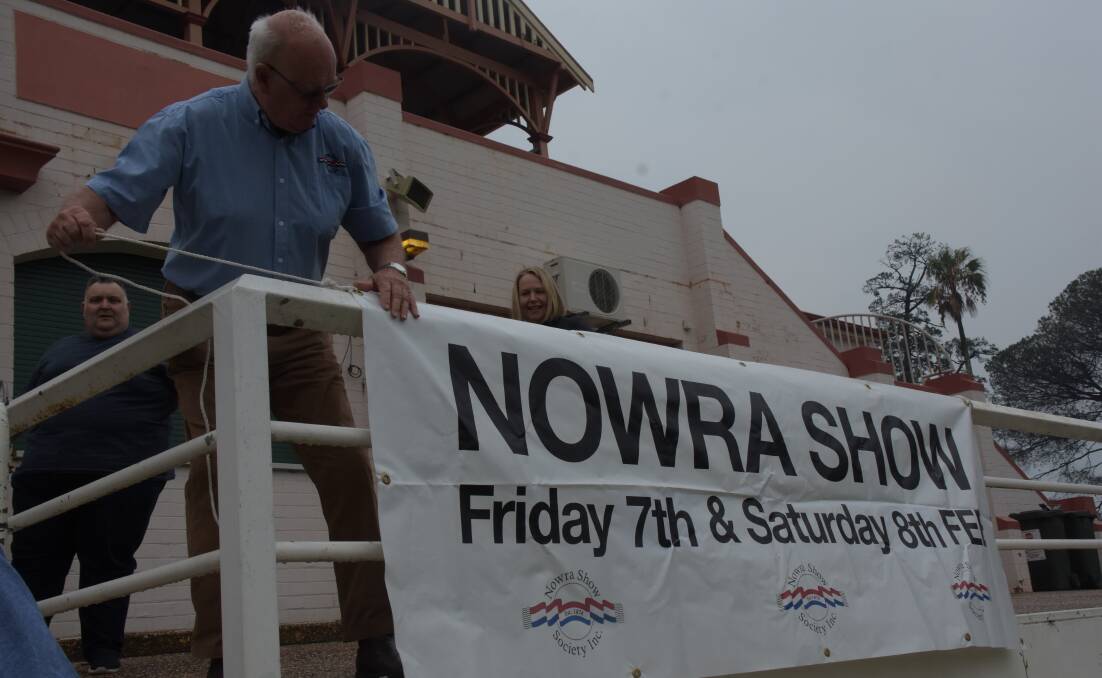 Nowra Show Society member Ralph Cook erects the banners in preparation for this year's event.
