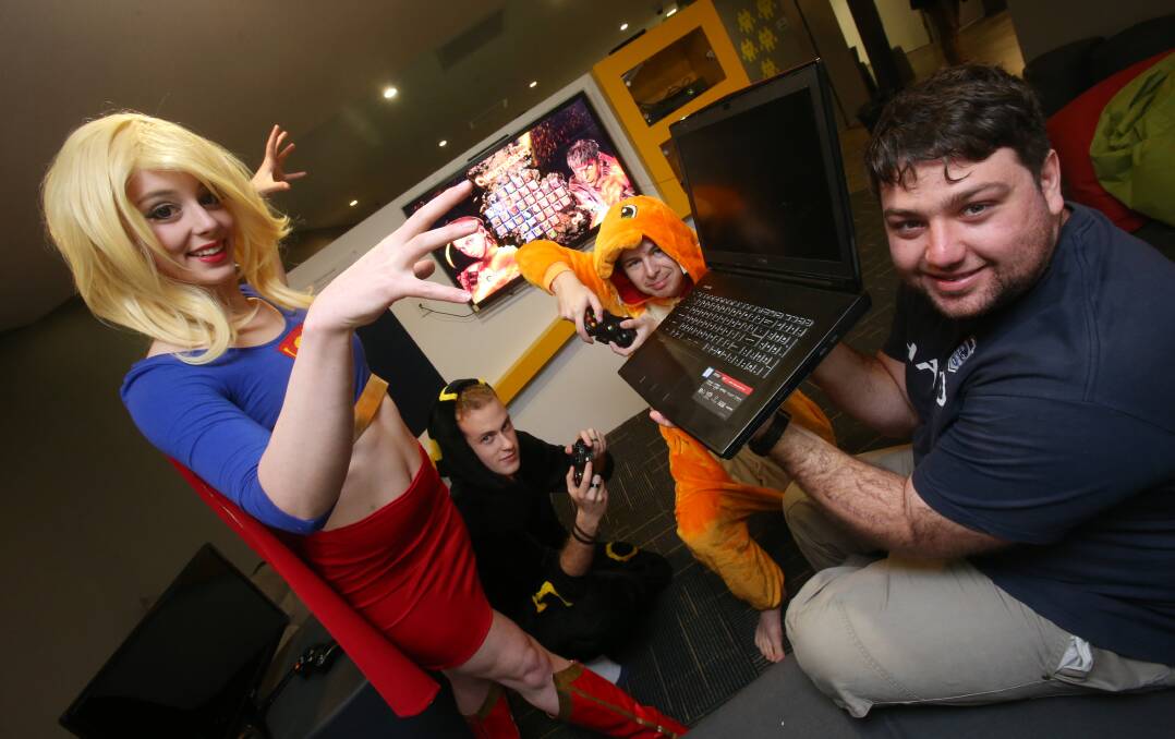 TECH HEADS: Members of the UOW Video Games Association - Emily Coleman, Michael Kosteski, Luke Pate and Brendon Potter - whoe are hosting Wollongong's next GameFest this weekend. Expect plenty of Pokemon Go paraphenalia. Picture: Robert Peet