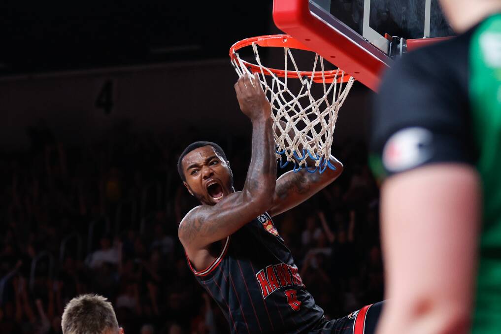 Hawks star Gary Clark makes a slam dunk during the January 28 game against the NZ Breakers, much to the delight of the thousands of fans. Picture by Anna Warr.