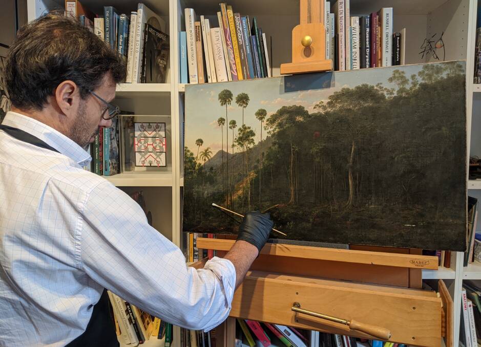 David Stein restoring the Eugene von Guerard painting, Cabbage Tree Forest American Creek, New South Wales for the Wollongong Art Gallery. Picture: David Stein & Co