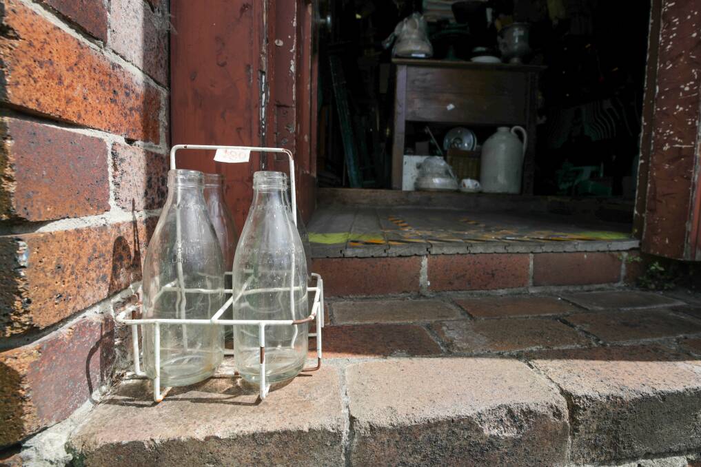 Empty milk bottles from decades ago were left out for the milkman to take and replace with fresh ones - currently for sale at Wombat in Thirroul. Picture by Adam McLean.
