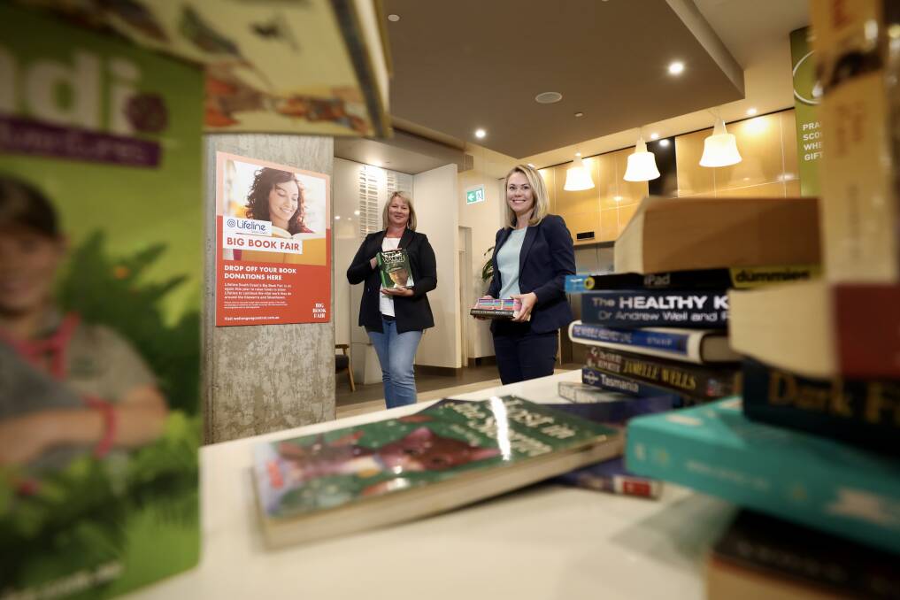 BOOK DEAL: More than 80,000 books will be available for little more than loose change at the Lifeline Book Fair this weekend. Lifeline South Coast CEO Renee Green with Wollongong Central manager Jasmin North. Picture: Adam McLean 