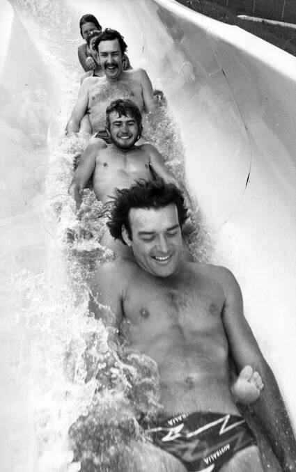 FLASHBACK: Owner of Jamberoo Action Park, Jim Eddy, and friends on the water slide in 1981. Picture: File