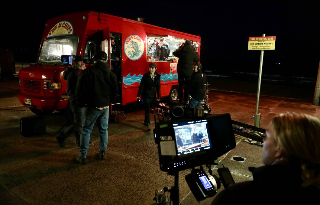 A WRAP: Princess Productions film their last scenes in Thirroul on Wednesday night at Thirroul beach with fake fish'n'chips van set. Picture: Adam McLean