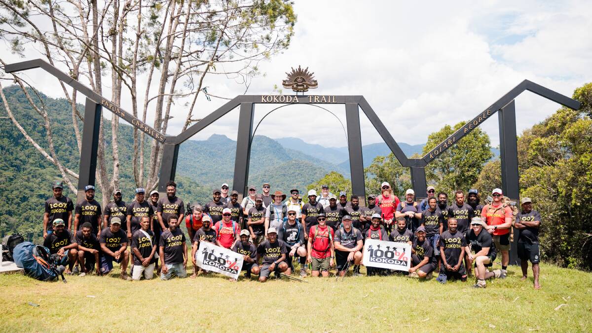 Making it to the finish-line - the group with their '100% Kokoda' tour guides. Picture by Warren Keelan.