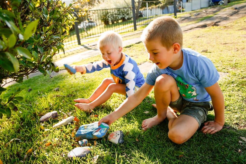 ROCK STARS: Two-year-old Charlie Loder and his five-year-old brother Patrick have been painting rocks and collecting some to re-hide around Woonona and Bulli. Picture: Anna Warr