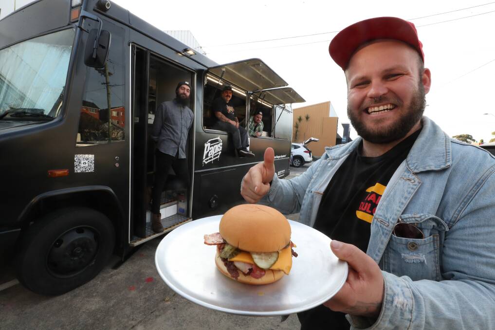 HOT WHEELS: Ashley O'Neill, Andrew Juskiw, Chay McGregor and Barry Pearson with Papi's Burger truck at Fairy Meadow. The old Mercedes school bus, dubbed Thirsty Merc, is the newest member of the Papi's clan with delights served out its windows from Wednesday to Sunday. Picture: Robert Peet