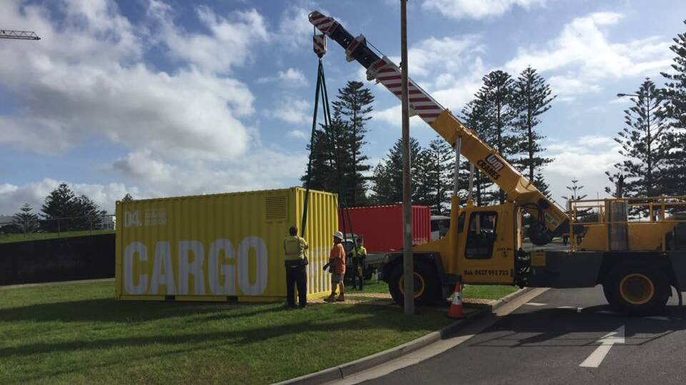 BIG DEAL: A shipping container being positioned near City Beach, Wollongong on Tuesday afternoon. The ‘Container’ exhibition looks at the history and impact of containerisation and the way the shipping container has changed the world. Picture: Wollongong City Council