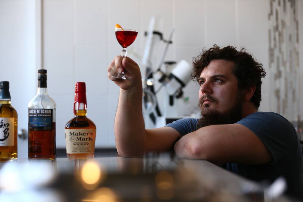 Orion Leppan Taylor with the cocktail Come On Eileen, which uses Makers Mark whiskey blended with Illawarra plum from their ROTOVAP machine. Picture: Wesley Lonergan