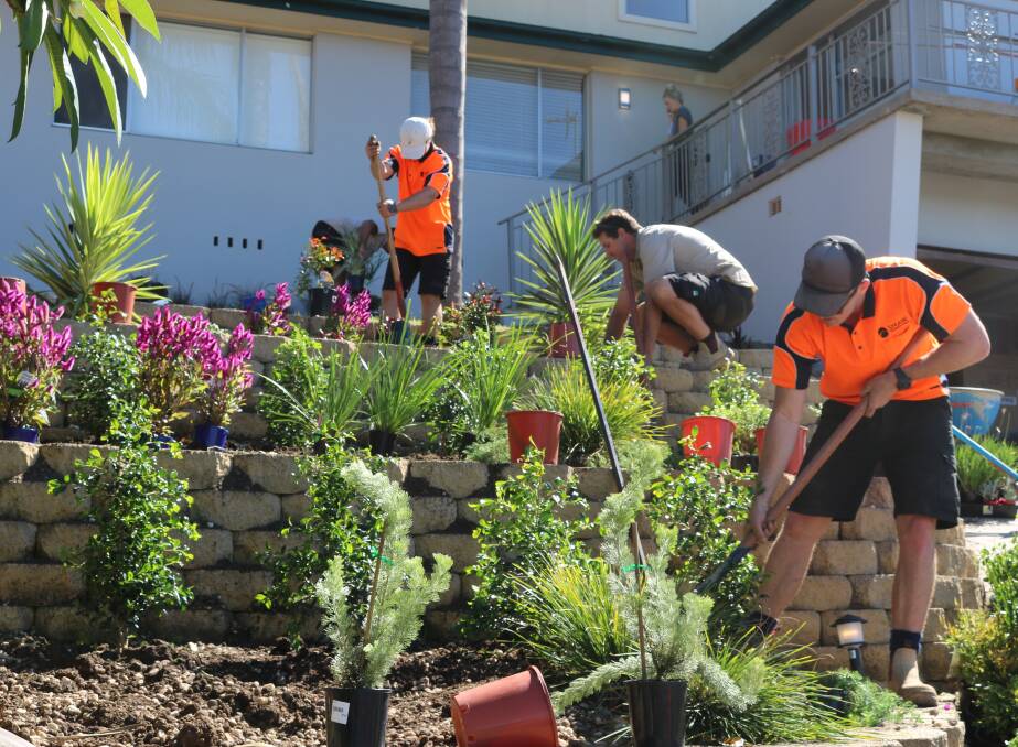 Workers from Shaw Landscape Group in East Corrimal create the dream garden for Jess and Fotis Lambis' new Kanahooka property, on reality show Buying Blind. Picture: Supplied
