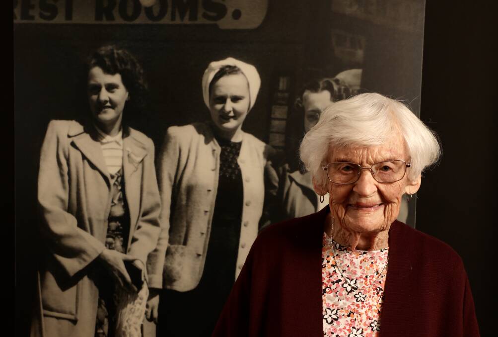 Beryl Powell, now aged 91, stands in front of a life-size portrait of herself with her aunt and mother at the side of Greens Newsagency (originally on the corner of Crown St and Globe Lane) - a street photograph taken in the mid-20th century. Picture: Adam McLean