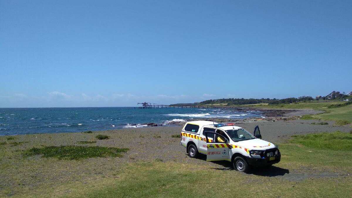 Fire and Rescue NSW are currently on scene with HAZMAT crews, along with the Rural Fire Service and police - however, even emergency services have been told to stay at least 100 metres away from the a military canister that washed up on shore. Picture: Wesley Lonergan