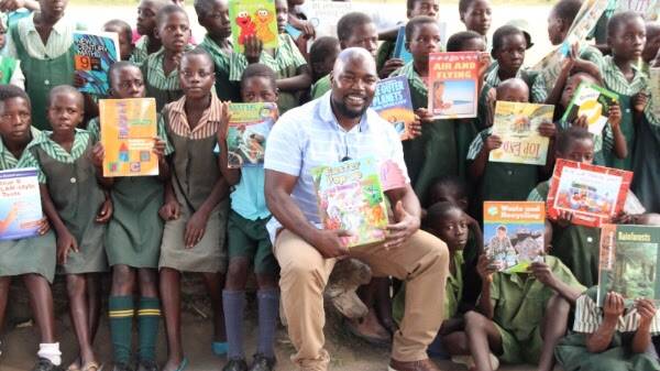 CREATING WISDOM: Dr Alfred Chidembo delivering the first load of books to Mavhurazi Primary School in Zimbabwe, one of six recipients of Books For Zim. Picture: Supplied
