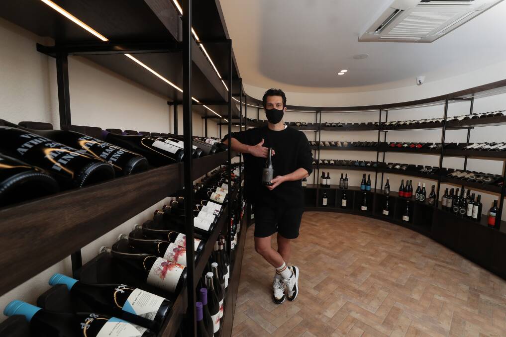 NICE DROP: Kevin Duarte with a selection of beverages from Australia and abroad in the temperature controlled room at Sonny's Wine Shop in Wollongong. Picture: Robert Peet