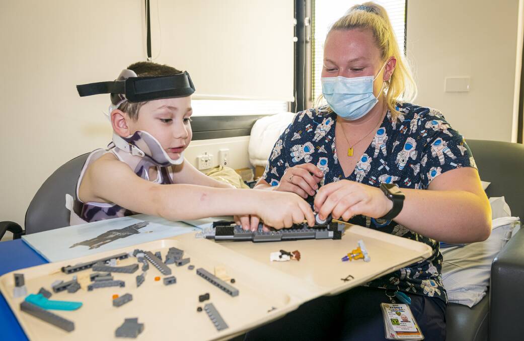 Vincent and nurse Bronte playing with lego during his stay at the Sydney Children's Hospital. Picture: SCH