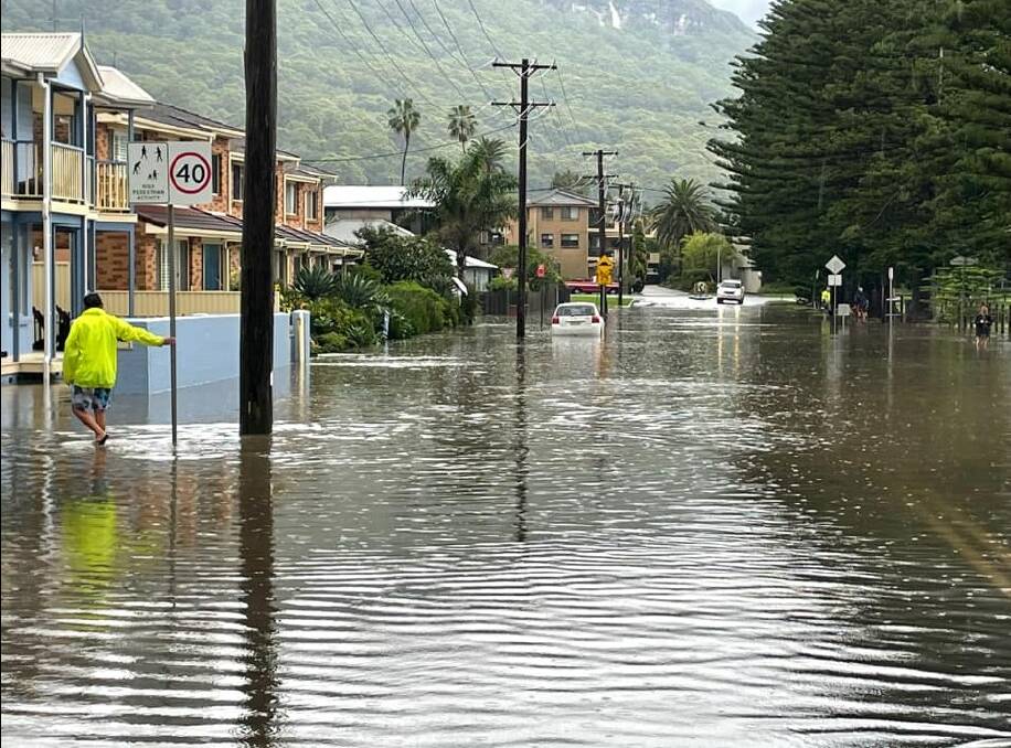 The Esplanade in Thirroul went underwater quickly last Saturday, despite local residents regularly trying to clear the storm water drains of pine needles. Picture: Jon Barbaro