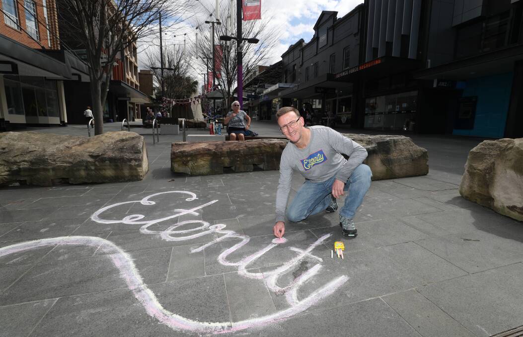 Josh Reid (co-producer of the film Written In Chalk) with one of the many 'eternity' tags that have sprung up across Wollongong. Picture: Robert Peet