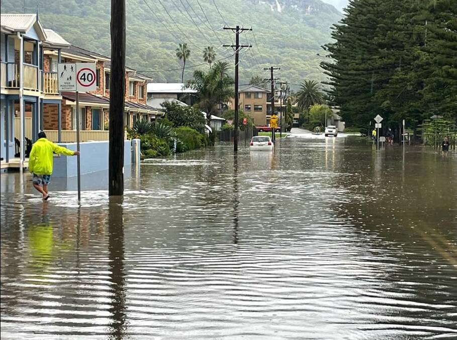 Jon Barbaro snapped this picture of The Esplanade flooded in Thirroul after a storm on Saturday March 26. Many residents in waterlogged streets resorted to wading in floodwater to unblock drains to try and ease rising water. Picture: Jon Barbaro