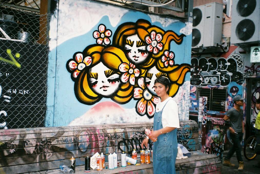 Multi-talented artist Aki Yaguchi and one her previous murals. Picture supplied.